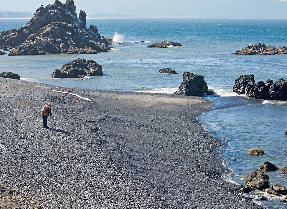 Photographer, black round rocks, Yaquina Head Outstanding Natural Area