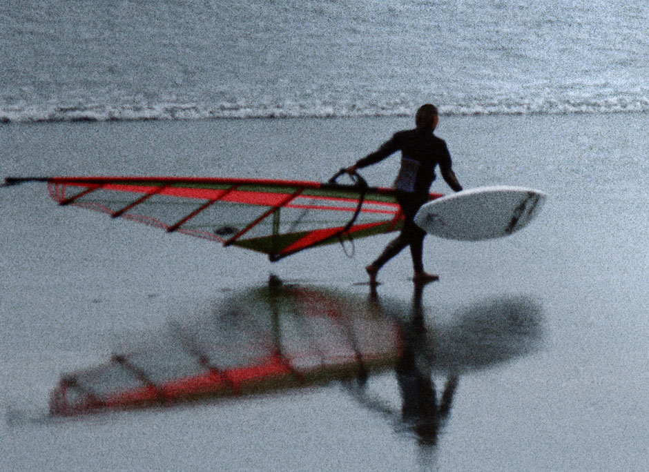 A windsurfer takes a chilly dip