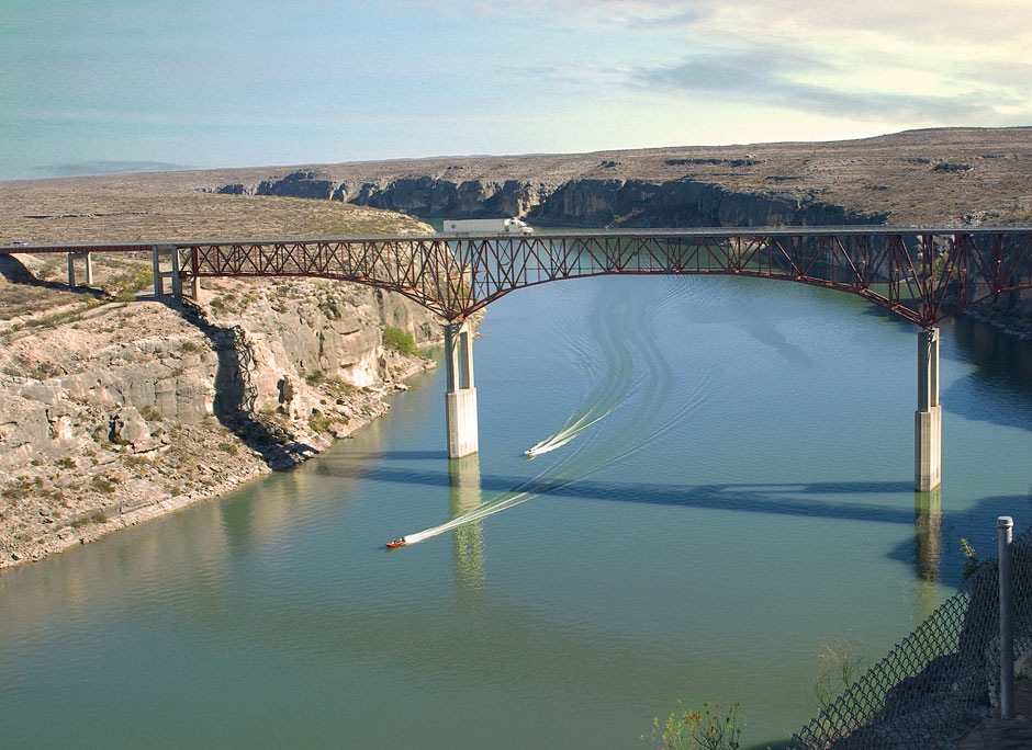 Buy this Boaters on the Pecos River under Pecos Bridge. Trucks travel to Del Rio photograph